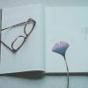 brown eyeglasses on opened book