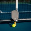 A tennis racket and ball on a tennis court