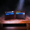 brown leather bifold wallet on table